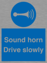 sound-horn-drive-slowly-warehousing-and-delivery-sign~